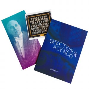 Spectemur Agendo book with postcard and insert on a white background.